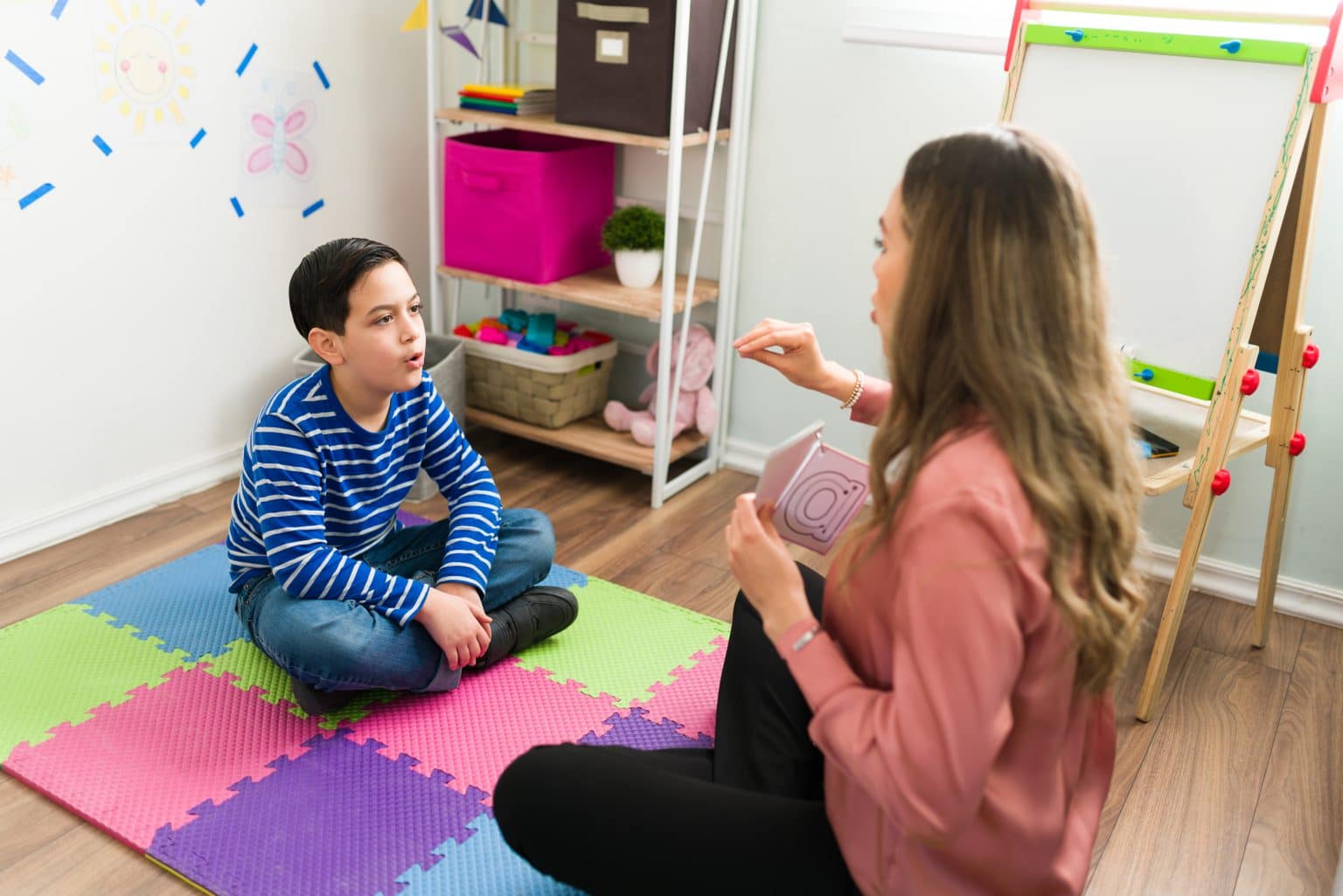 Auditory-Verbal-Therapy-session Speech pathologist helping a child through auditory verbal therapy